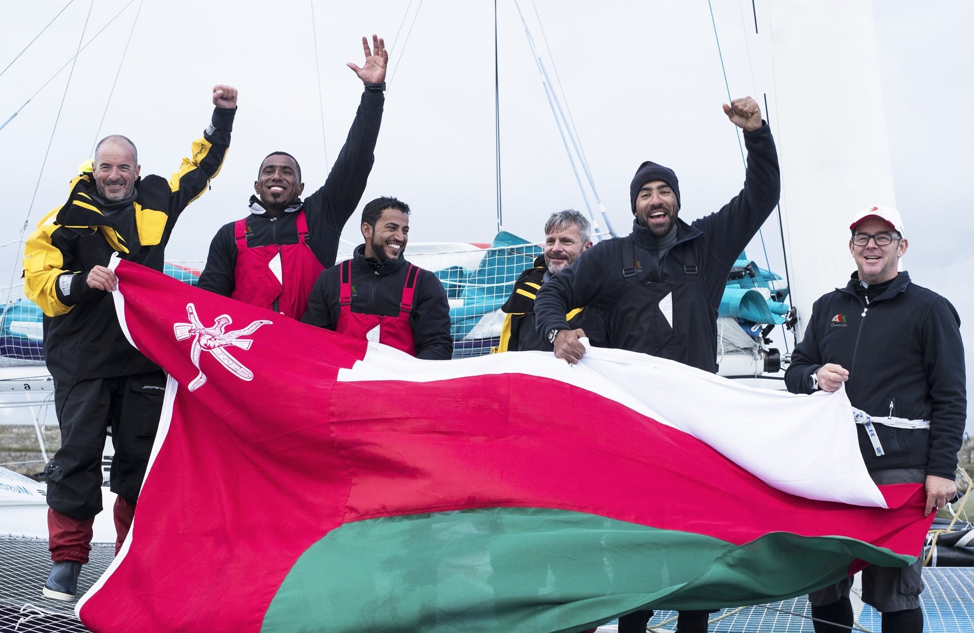 Musandam-Oman Sail set a new world record for sailing around Ireland* and posted a sensational victory in the 2016 Volvo Round Ireland Race after a cliff-hanger finish with just minutes separating the three giant trimarans on the line. Arriving back in Wicklow Bay, after a thrilling contest with the other MOD70s, Phaedo and Concise, for most of the 700 nautical mile course, Sidney Gavignet’s crew were exhausted but exhilarated by their victory and the new record, which they had set themselves last year beating Steve Fossett’s longstanding Lakota record from 1993.  The crew crossed the finish line at 03:47 local time as dawn was breaking after setting a new time of 38 hours 37 minutes and 7 seconds, which was more than two hours faster than their previous time of 40 hours, 51 minutes and 57 seconds set last year.  Racing with just six crew, including Oman’s three leading offshore sailors Fahad Al Hasni, Yasir Al Rahbi and Sami Al Shukaili, Musandam-Oman Sail claimed line honours while Phaedo 3 were hot on their heels and arrived six minutes later with the third MOD70, Concise 10 trailing by a single minute. The final few moments turned their race upside down, said Gavignet, since for most of the time, they had been chasing the other boats until an opportunity came up to take the lead less than a mile from the end.  “It feels fantastic because at times we were slower than the other boats and I was thinking we might finish last and lose our record but a few minutes before the finish we had a bit of luck and were close enough to the others to take advantage. The guys showed real commitment – we had no watch system so didn’t sleep much and didn’t use the bunks to keep more weight at the back so they were sleeping on the floor and on wet sail bags. They have been grinding a lot and worked really hard so they are exhausted but happy.”  It had been without question the most demanding race he had ever done, added Irishman Damian Foxall as he stepped off the boat, but coming out on top represented a new high in his long career. “I have done a few round the world races but this was up there as one of the best,” he said.  “Racing with six meant one or two less than the other boats so we only had one hours sleep each at the most but being so close to the other boats was so motivating and intense.  “We knew at times we were off the pace but we kept pushing hard and found opportunities to come back into the race. There was a reasonable chance we were going to lose our record so Sidney was fairly tight-lipped coming down the east coast but it is very satisfying to win AND set a new record because this race is not for the faint hearted.”  Al Hasni, who shared helming duties with Gavignet and Foxall agreed it had been tiring but rewarding. “We are really happy with this result; it makes me very proud to raise the Omani flag in Ireland for the second time with this world record - we dedicate our win to the Sultanate of Oman. In the last few miles, we were aware that there were potential passing lanes near the coast so we moved into position which worked and we were able to gain the advantage when it mattered most.  “It was really hard and we thought we had missed our opportunity but those last few minutes turned it round so we are very happy.”  David Graham, Oman Sail CEO, was delighted with the team's performance: "This was one of the most difficult challenges that the guys on Musandam-Oman Sail have faced, I could hear the smile on Fahad's face when he answered the satellite phone when I called them as they crossed the finish line to congratulate the team on both the victory and the record.  "We are especially pleased that Fahad, Yasir and Sami are an integral part of the race crew for a second Round Ireland Record - the team has been working hard and it is great to see their efforts pay off. This experience and success is key to their pathway. They had world class mentors on board with Sidney, Damian and Jean Luc [Nelias] and it all worked to deliver our desired result." The crew will return to training immediately after food and sleep in preparation for the delivery to Quebec, Canada, where they will set off on the Transat Quebec – St Malo Race across the Atlantic on July 10, returning to Europe for an action-packed summer season of events.  *pending ratification by World Sailing Speed Record Council